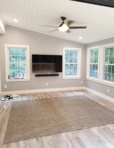 A living room with hardwood floors and a flat screen tv.